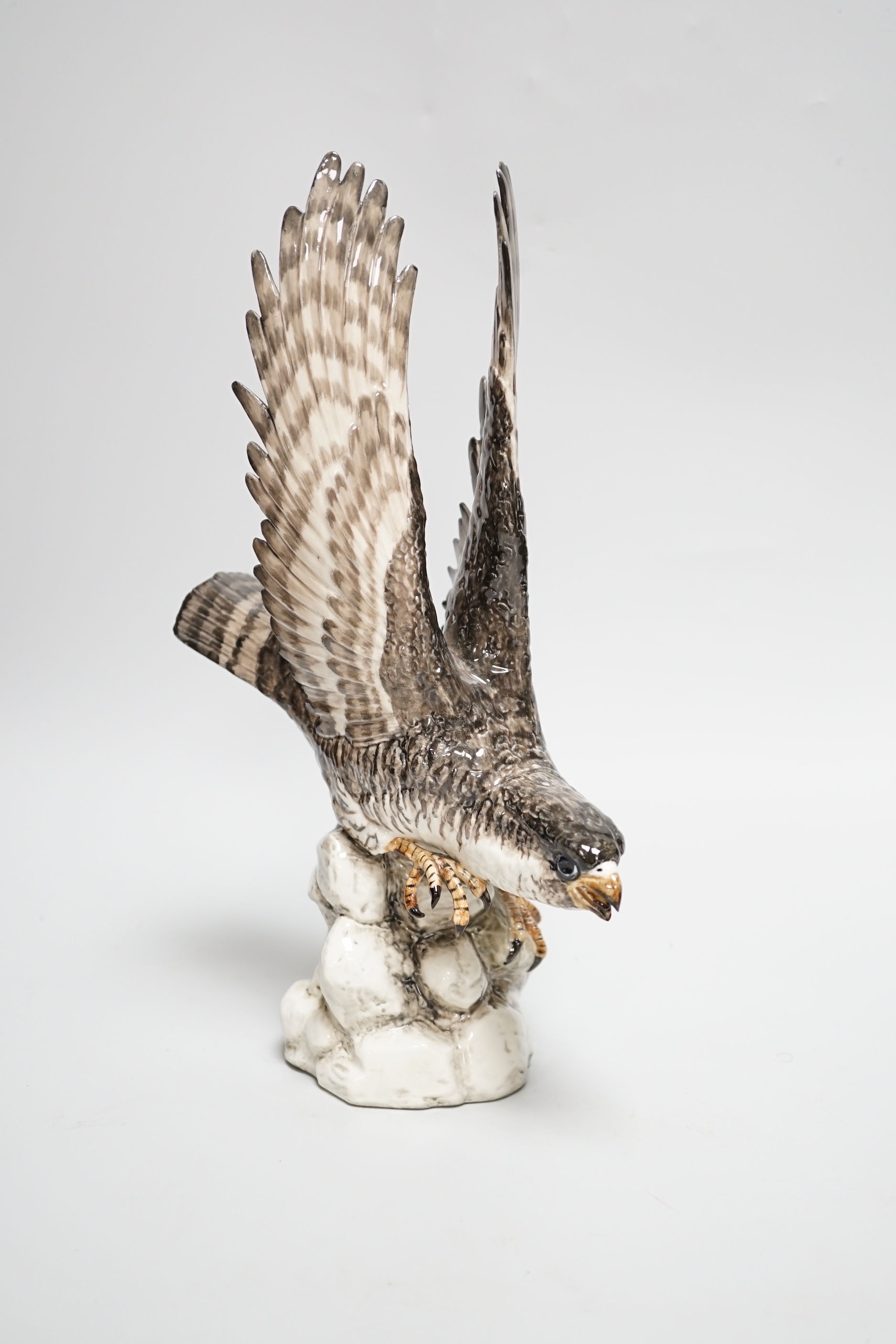 A Spanish porcelain falcon, with ‘PM’ mark to base and ‘Syra P. Garcia 43 Barcelona’ applied label, 30.5cm high